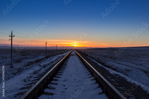 Railway receding into the distance at sunrise © cherniyvg
