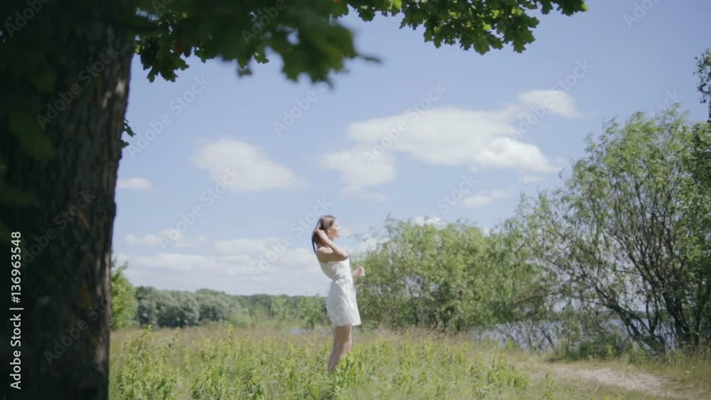 Young pretty woman on meadow. Enjoying sunlight Young pretty woman on meadow. Enjoying sunlight