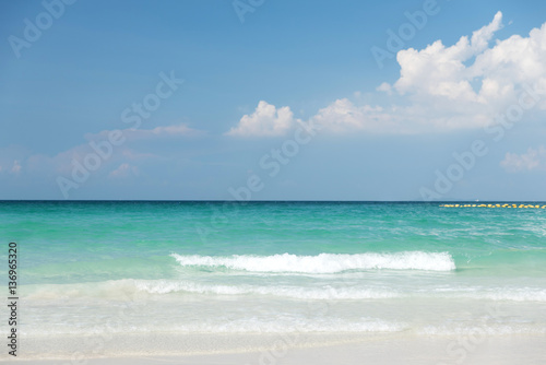Beautiful gentle wave at the shallow beach with blue sky © peangdao