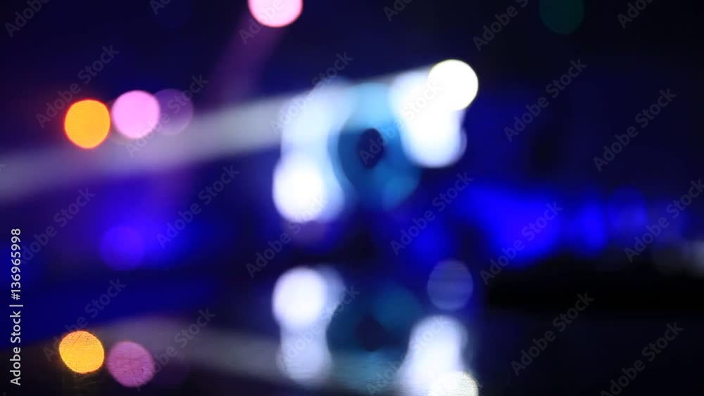 Defocused scene in the night club with bokeh lights and people silhouettes