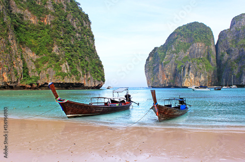 Holiday vacation concept background - Long tail boat on tropical beach with limestone rock, Krabi, Thailand © Gelia