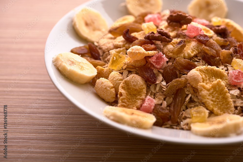 flakes with dried fruit, granola on the plate flakes with dried fruit, granola on the plate