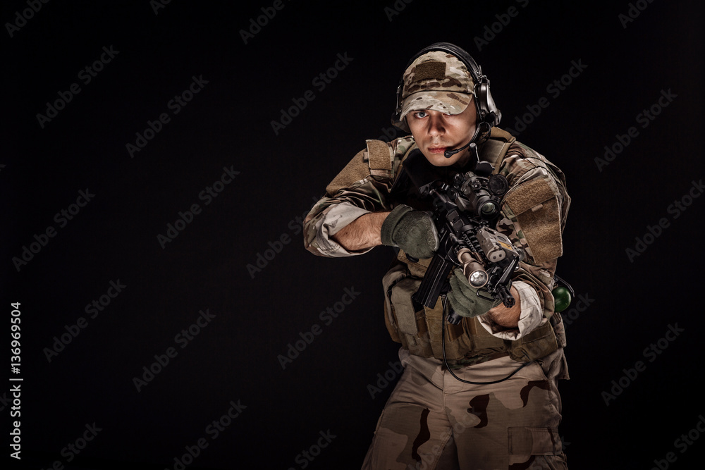 Portrait soldier or private military contractor holding sniper r Portrait soldier or private military contractor holding sniper r