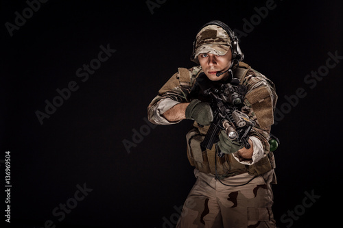Portrait soldier or private military contractor holding sniper r
