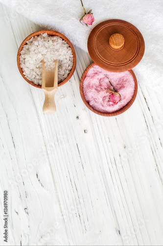 White and pink sea salt for spa on white wooden table