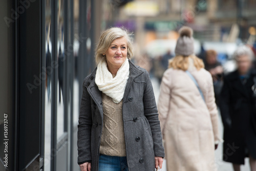 Photography Beautiful senior woman on a walk in the city. Winter