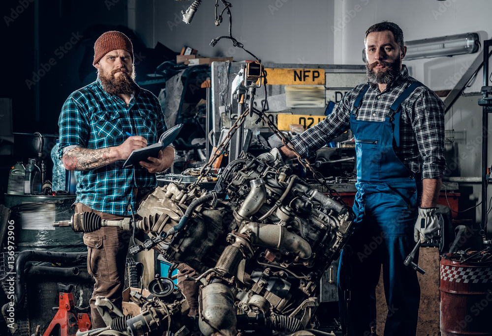 Two men in a garage.