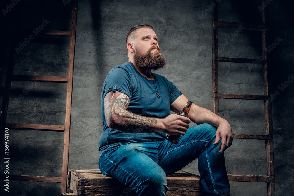 A man holds beer bottle.
