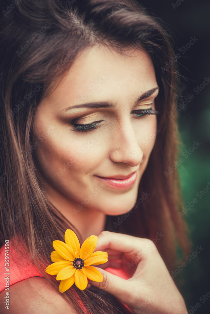 Happy beautiful young woman in spring blossom park. Pretty Girl with Spring Flowers. Fashion Model Outdoors Happy beautiful young woman in spring blossom park. Pretty Girl with Spring Flowers. Fashion Model Outdoors