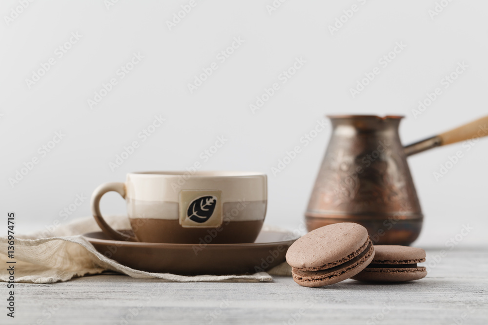 Breakfast at workplace. Coffee and chocolate macaroons Breakfast at workplace. Coffee and chocolate macaroons