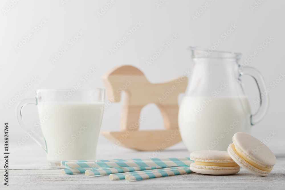 Jug of milk and cup with macaroons Jug of milk and cup with macaroons