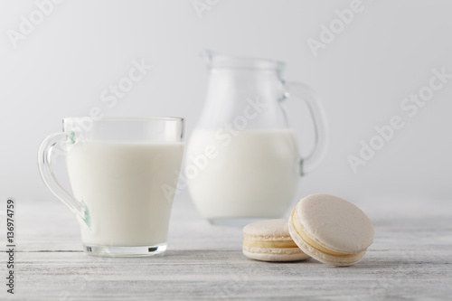 Jug of milk and cup with macaroons