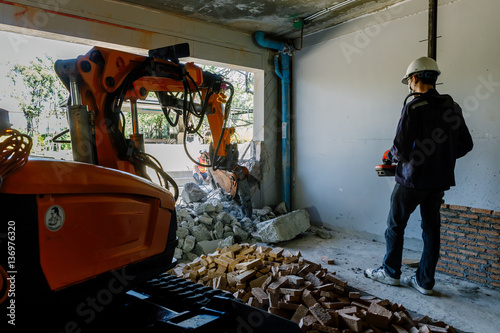 Robot Equipment is destroying the walls of the house photo