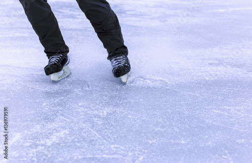 A man riding on the open ice-skating.