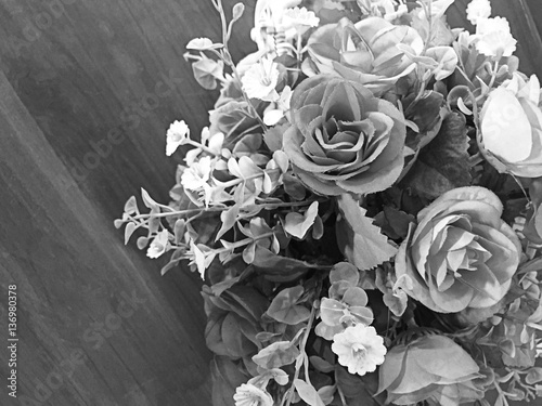 Bouquet of gray roses fake on a wooden table