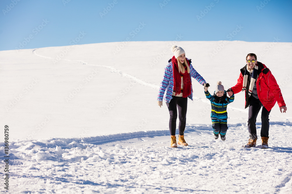 Attractive family having fun in a winter park on mountain