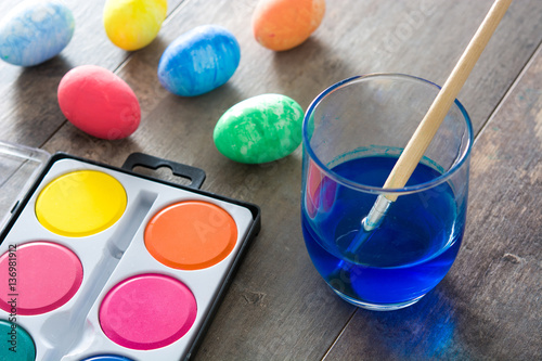 Fotografie Painting Colorful Easter eggs on wooden background