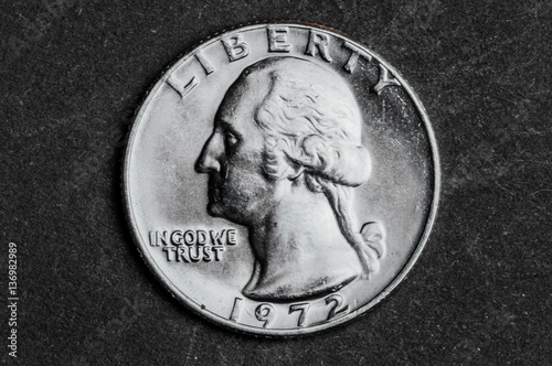 Close up of half american dollar coin on black background - business concept