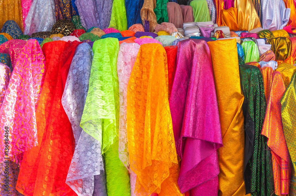 Rolls colorful of brightly coloured fabrics and cloths store