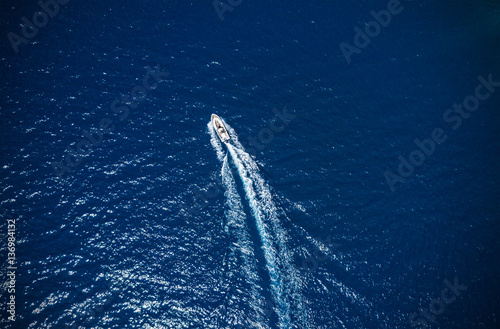 Aerial view of small boat flowing in sea