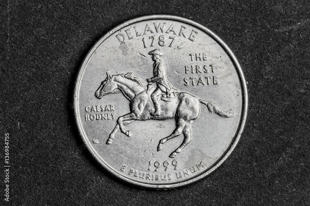 Close up of Delaware first state quarter dollar coin on black