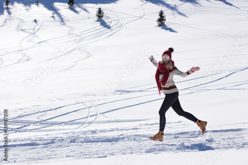 Running woman runner in winter mountains on snow.