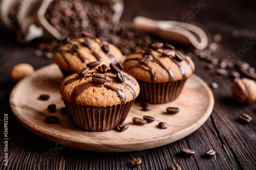 Coffee muffins with grated walnut and topped with chocolate