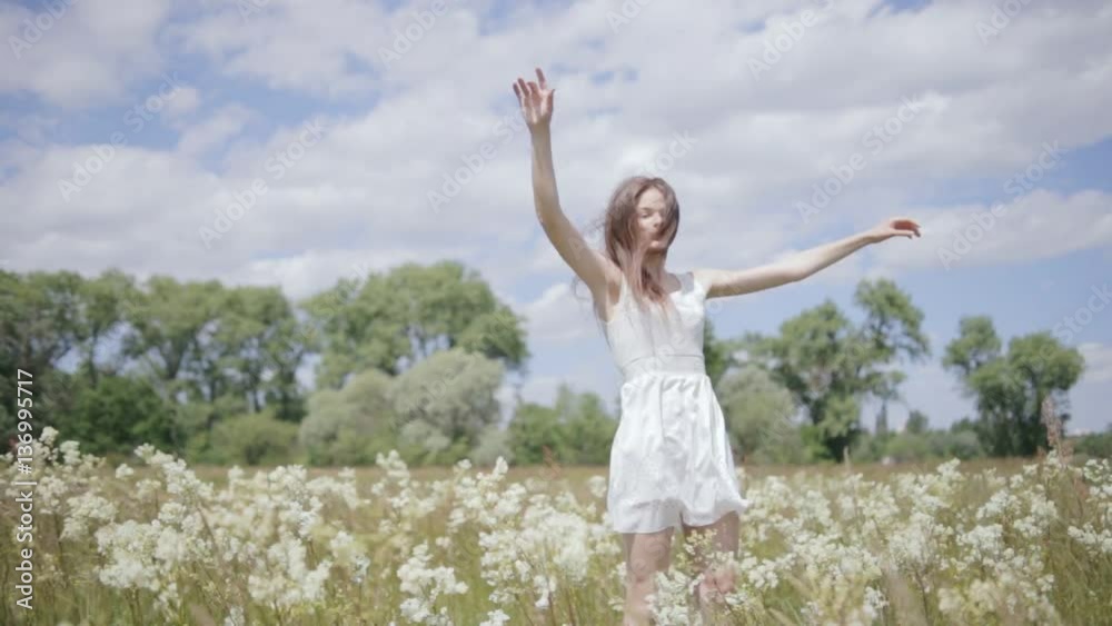 Young pretty woman on meadow jumping Young pretty woman on meadow jumping