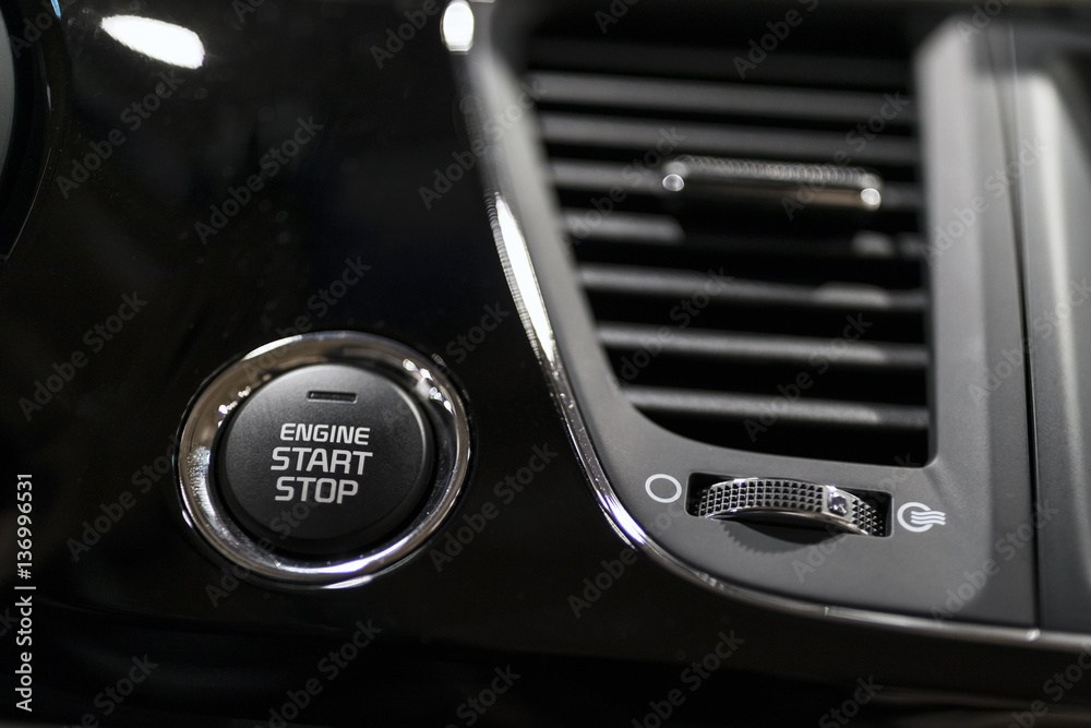 Car dashboard with focus on engine start stop button