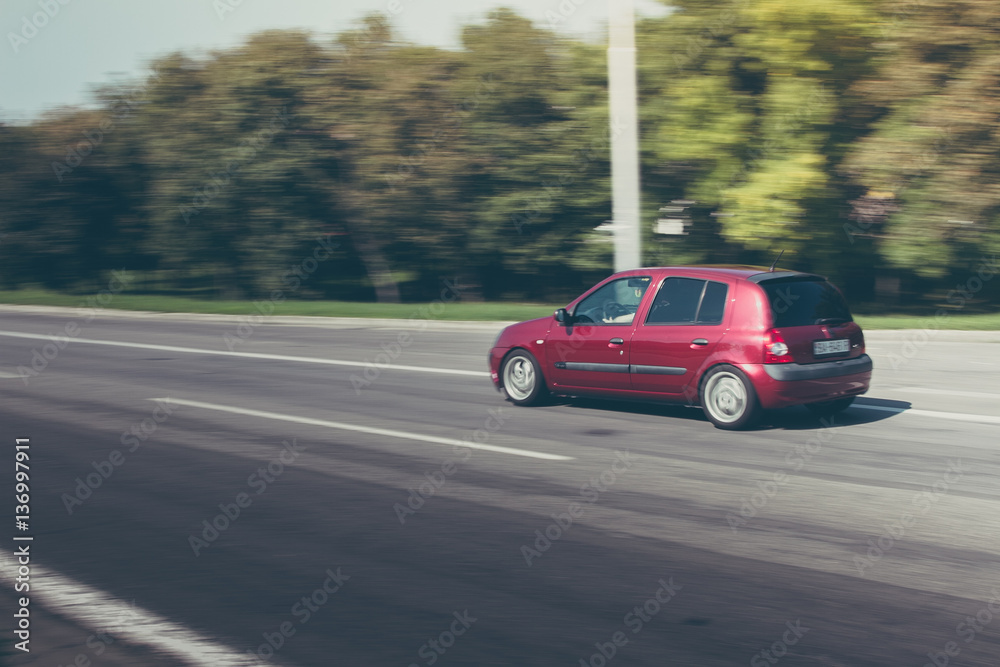 small red car speeding