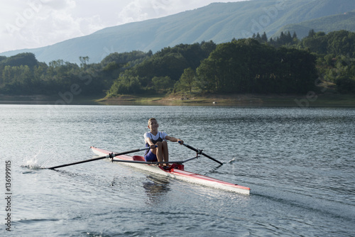 Child in the course of rowing on single