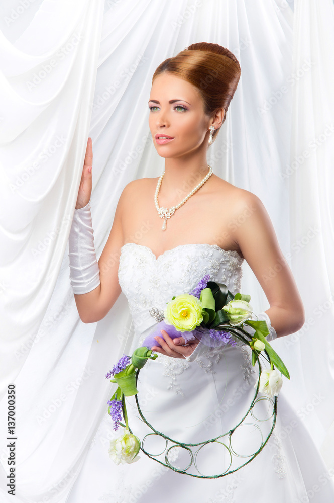Young, beautiful and emotional bride with a beautiful flowers