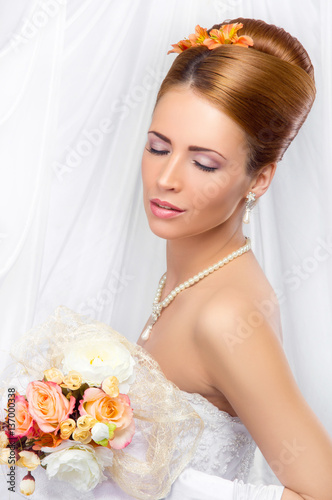 Young, beautiful and emotional bride with a beautiful flowers