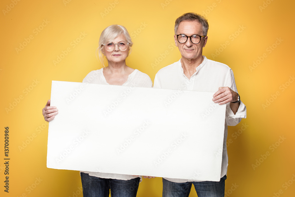 Happy senior couple with empty board. Happy senior couple with empty board.
