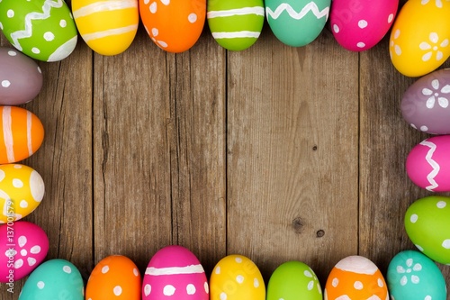 Photography Colorful Easter egg frame against a rustic wood background