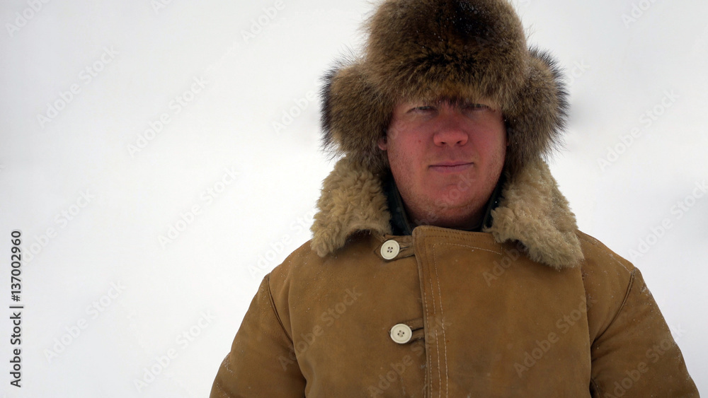 portrait man looking at the camera outdoors in the snow. portrait man looking at the camera outdoors in the snow.