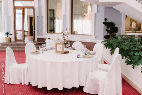 Wedding guest table, decorated with bouquet and settings © Olga