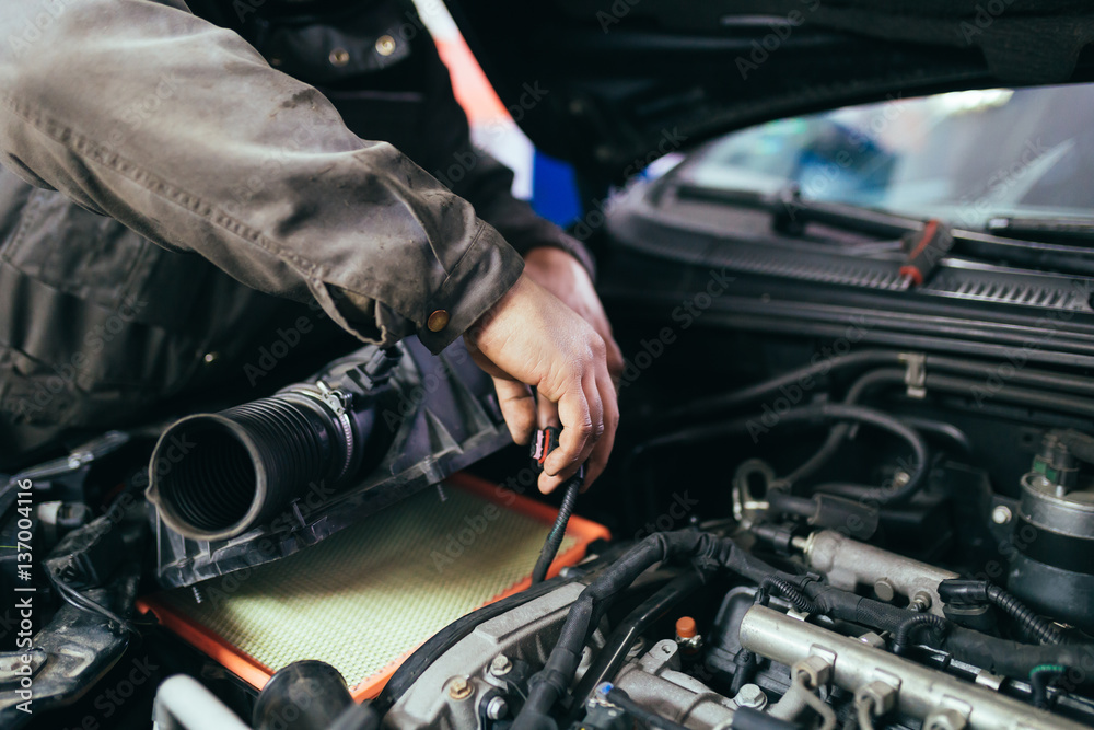 Auto mechanic repairing car. Selective focus. Auto mechanic repairing car. Selective focus.