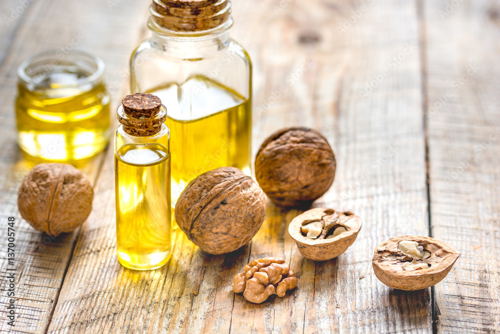 cosmetic and therapeutic walnut oil on wooden background cosmetic and therapeutic walnut oil on wooden background