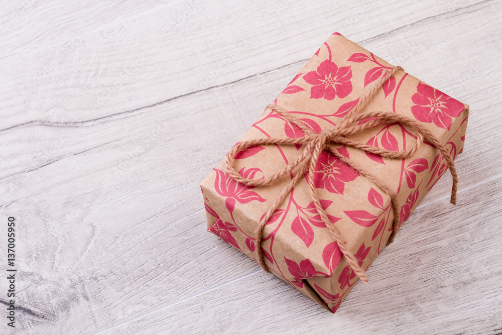 Gift wrapped with rope. Present box on wooden backdrop. Holiday is time of joy. Happiness from receiving a gift. Gift wrapped with rope. Present box on wooden backdrop. Holiday is time of joy. Happiness from receiving a gift.