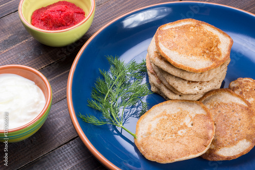 Russian buckwheat pancakes blini with cream and caviar photo