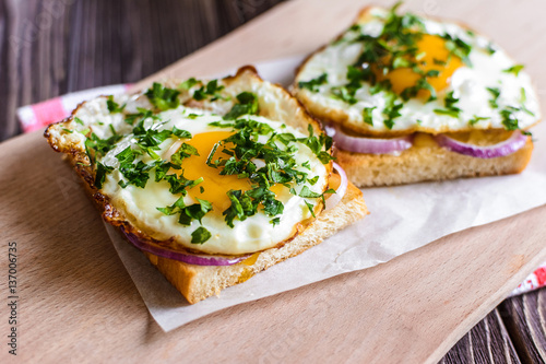 Open sandwiches with egg and cheese on a wooden background