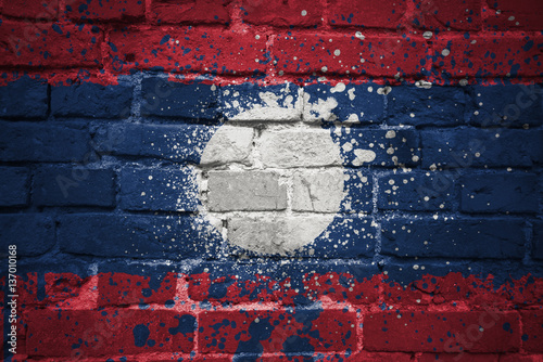 painted national flag of laos on a brick wall