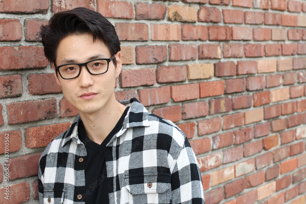 Attractive Asian man with glasses close up portrait Attractive Asian man with glasses close up portrait
