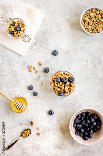Oat flakes with honey and berries on table background top view