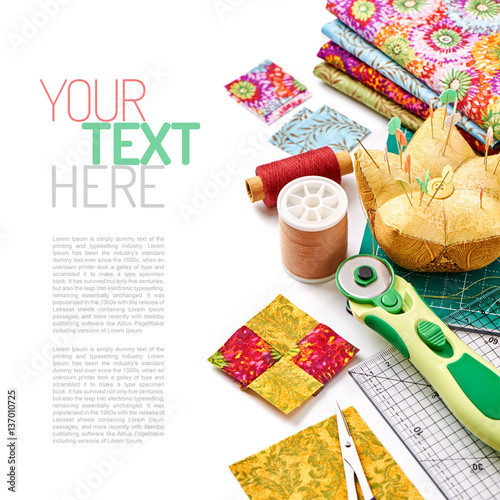 Accessories for quilting on a white surface, top view