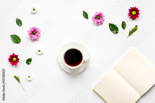 Froral flat lay with cup and notepaper top view mockup