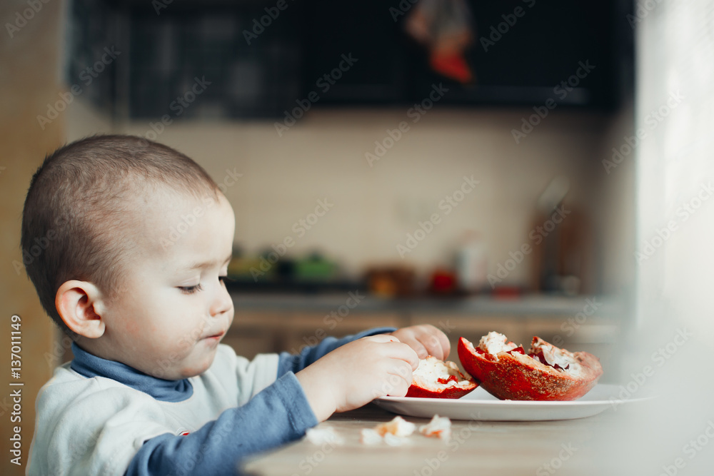 A child eating a pomegranate