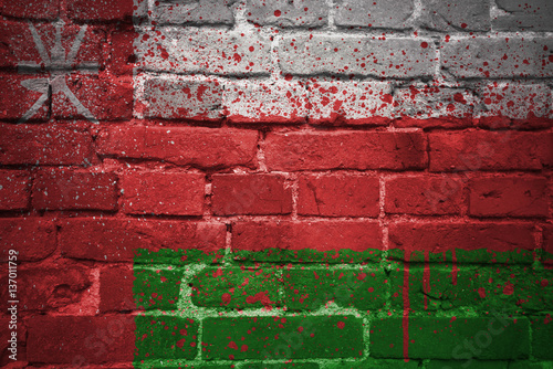 painted national flag of oman on a brick wall