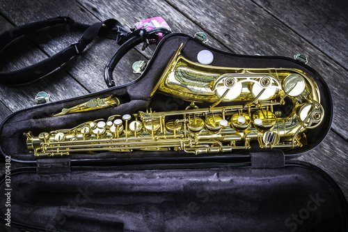 Golden alto saxophone in box photo